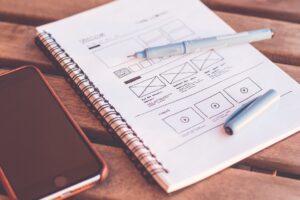 A web design plan drawn on a notebook
