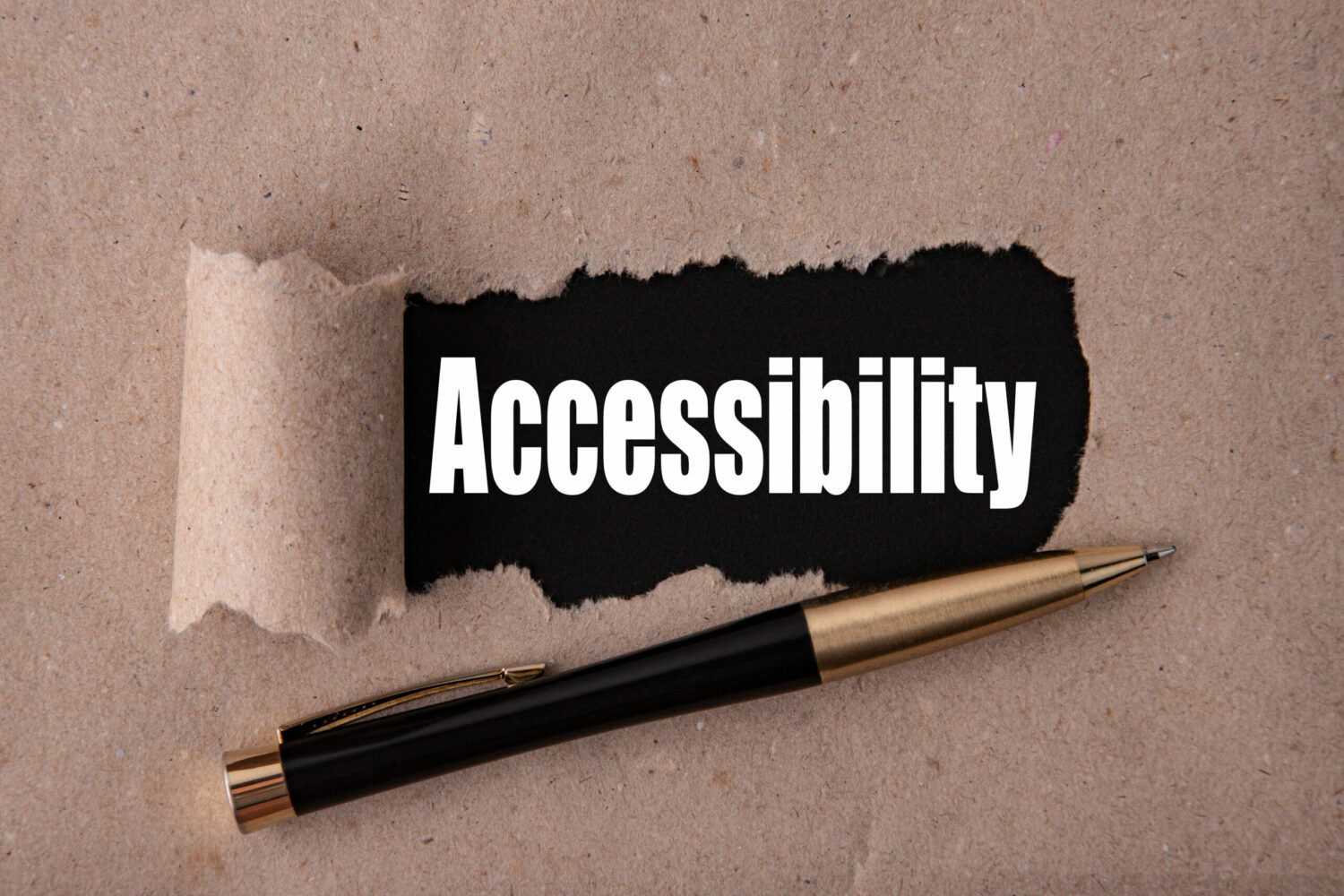 The word "Accessibility" is written under torn paper, with a pen just underneath it