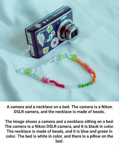 A nikon camera and a bead necklace on a bed